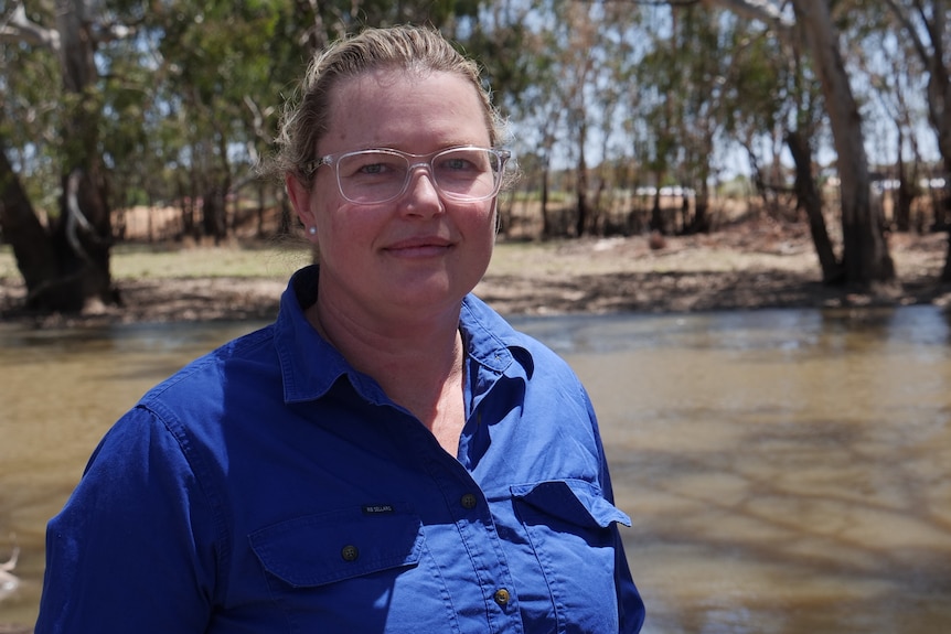 A close-up of a woman by a river