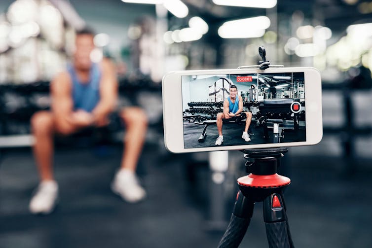 A man filming a gym